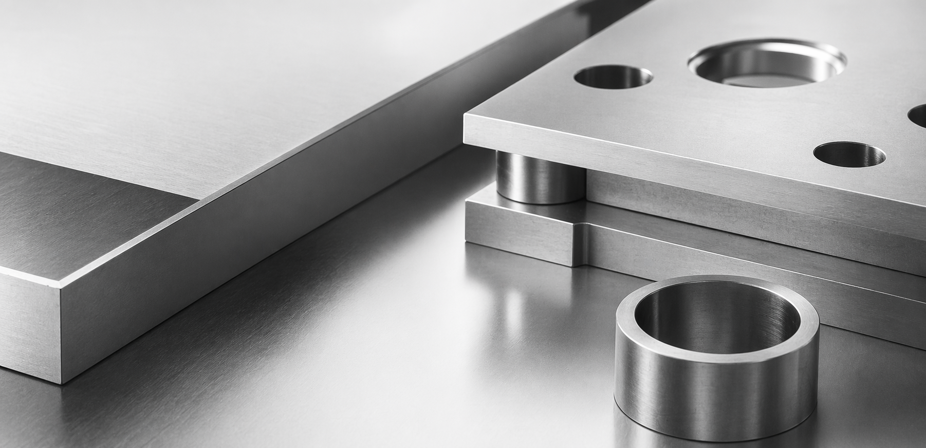 Precision steel components arranged on a brushed metal surface